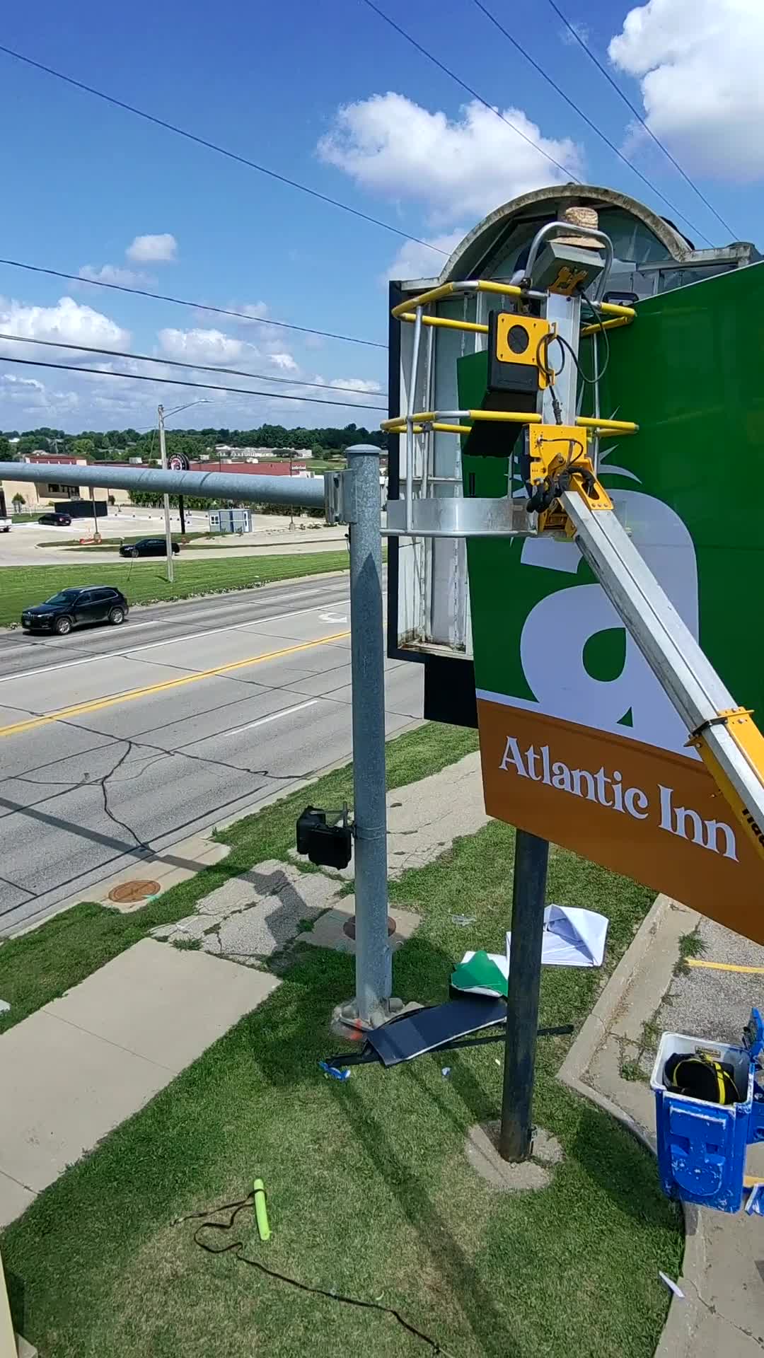 Installation crew working on the Atlantic Inn pole sign from a lift
