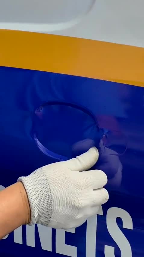 Hands applying and smoothing a fleet vehicle wrap
